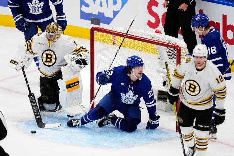 Toronto Maple Leafs' Matthew Knies celebrates his goal on Boston Bruins goaltender Jeremy Swayman with Mitch Marner during the second period of action in Game 3 of an NHL hockey Stanley Cup first-round playoff series in Toronto on Wednesday, April 24, 2024. (Frank Gunn/The Canadian Press via AP)