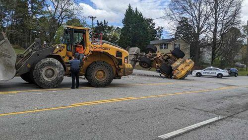 A Gwinnett County police officer used a local waste management company's front-end loader to disable another front-end loader driven by a disgruntled employee who led officers on a chase along public roads near Duluth on Saturday.
