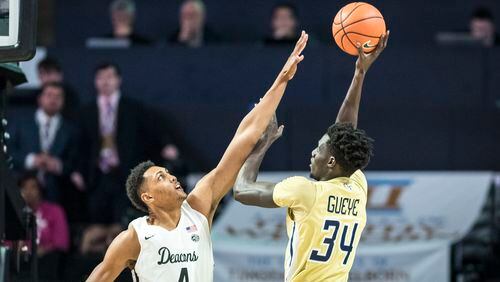 Georgia Tech forward Abdoulaye Gueye (34) shoots over defense from Wake Forest center Doral Moore (4) during an NCAA college basketball game, Wednesday, Feb. 14, 2018 in Winston-Salem, N.C. (Andrew Dye/The Winston-Salem Journal via AP)