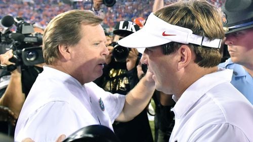 Georgia coach Kirby Smart and Florida coach Jim McElwain meet after last year’s game in Jacksonville.