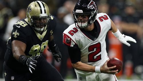 NEW ORLEANS, LA - NOVEMBER 22:  Matt Ryan #2 of the Atlanta Falcons runs with the ball as Sheldon Rankins #98 of the New Orleans Saints defends at the Mercedes-Benz Superdome on November 22, 2018 in New Orleans, Louisiana.  (Photo by Chris Graythen/Getty Images)