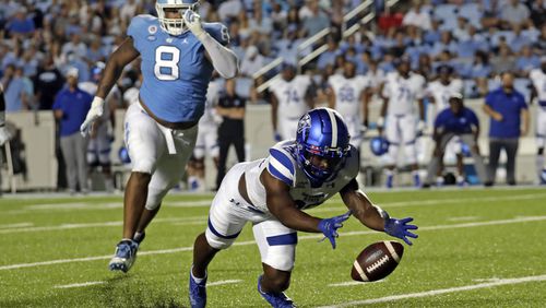 Georgia State running back Marcus Carroll (23) scrambles to recover a fumble ahead of North Carolina defensive lineman Myles Murphy (8) during the first half of an NCAA college football game in Chapel Hill, N.C., Saturday, Sept. 11, 2021. (AP Photo/Chris Seward)