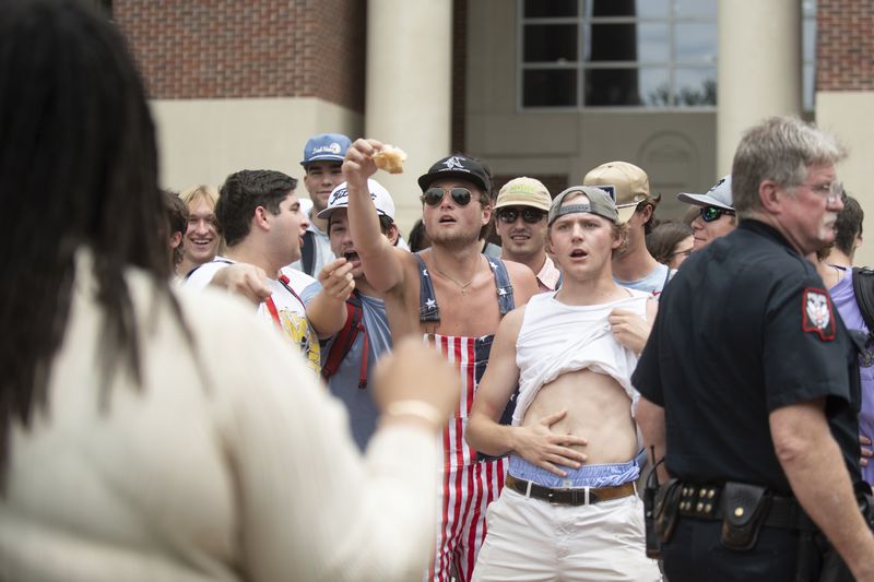 University of Mississippi student and counter-protester Connor Moore, center, taunts graduate student Jaylin R. Smith with a piece of bread during a protest in support of Palestinians on Thursday, May 2, 2024, outside the J.D. Williams Library on the school campus in Oxford, Miss. (HG Biggs/The Clarion-Ledger via AP)