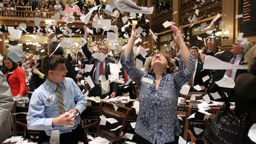 March 29, 2012 ATLANTA: Rep. Donna Sheldon, R-Dacula, center, throws paper into the air next to Thomas Allison after the House Majority Leader, Rep. Larry O'Neal yelled, "Sine Die, " to end the 2012 Legislative Session at the stroke of midnight on Legislative Day 40 at the Capitol Thursday afternoon in Atlanta, Ga., March 29, 2012. This was the finale of a three-month assignment to photograph the 2012 Legislative Session. I've heard a lot about, "Sine Die, " and enjoyed covering the event. I was focused on the Speaker of the House and waited for someone to react after throwing paper in the air. I saw Rep. Sheldon toss paper in the air and quickly turned to get off a few frames. I was happy to get a few before she put her arms down. Jason Getz jgetz@ajc.com