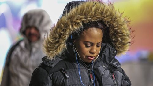 Eva Harden braved the cold outside the North Avenue MARTA Transit Station in midtown Atlanta on Tuesday. Forecasters have warned that it will be dangerously cold Wednesday.