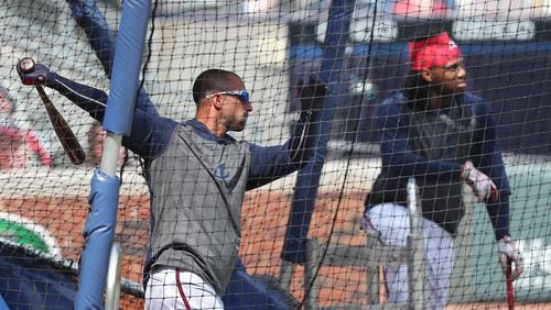 Braves outfielder Ronald Acuna watches as veteran outfielder Nick Markakis, who was activated Wednesday, takes batting practice before playing the Toronto Blue Jays on Wednesday, August 5, 2020 in Atlanta. Markakis had opted out of the season, but changed his mind to rejoin the team.   Curtis Compton ccompton@ajc.com