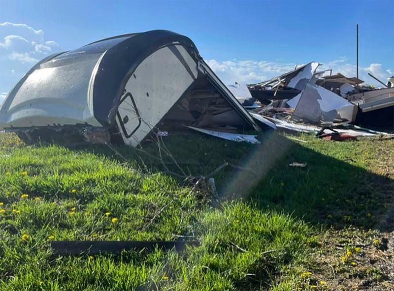 A camper damaged by storms is photographed on April 16, 2024, near Overbrook, Kansas. Two people were injured when their RV flipped over during a tornado; buildings and trees also were damaged in Overbrook. (Eric Ives/WIBW via AP)