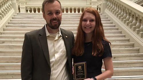 Riverwood International Charter School Principal Charles Gardner (left) stood with his student Dori Balser on the interior steps of the Georgia State Capitol after Balser received the 2017 Woodrow Wilson Community Service award from the Princeton Club in recognition of her outstanding service to her community.