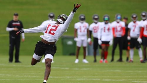 Mohamed Sanu goes out for a long pass leading the wide receivers through routes with Dan Quinn looking on during the first day of mandatory minicamp on Tuesday, June 12, 2018, in Flowery Branch.  Curtis Compton/ccompton@ajc.com