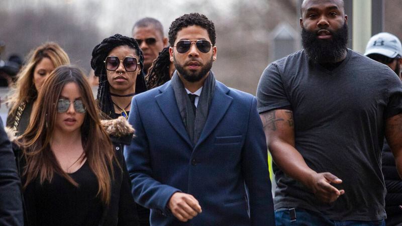 Empire actor Jussie Smollett, center, arrives at the Leighton Criminal Court Building for his hearing on Thursday, March 14, 2019, in Chicago. Smollett is accused of lying to police about being the victim of a racist and homophobic attack by two men on Jan. 29 in downtown Chicago.   (Ashlee Rezin/Chicago Sun-Times via AP)