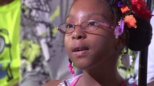 Tamesha Brittenum, an 8-year-old who was born with spina bifida, woke her family in time to get out of a burning house. (Credit: Channel 2 Action News)