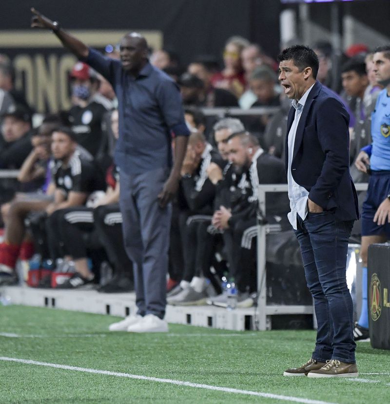 Chicago Fire FC head coach Ezra Hendrickson (left) and Atlanta United head coach Gonzalo Pineda are seen late in their game Saturday, May 7, 2022 at the Mercedez-Benz Stadium. (Daniel Varnado/For the Atlanta Journal-Constitution)