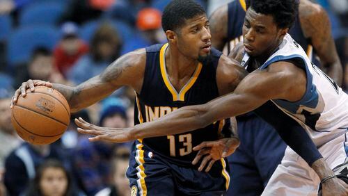 Indiana Pacers forward Paul George (13) drives against Minnesota Timberwolves guard Andrew Wiggins during the second half of an NBA basketball game in Minneapolis, Saturday, Dec. 26, 2015. The Pacers won 102-88. (AP Photo/Ann Heisenfelt)