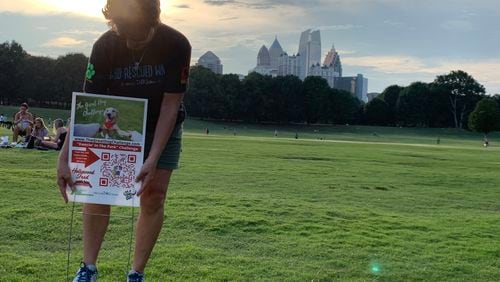 Jill Waddell placing signs for the Great Dog Challenge at Piedmont Park in 2020 as an alternative to her Rescue Dog Games festival, canceled due to the pandemic. CR: Rodney Ho/rho@ajc.com