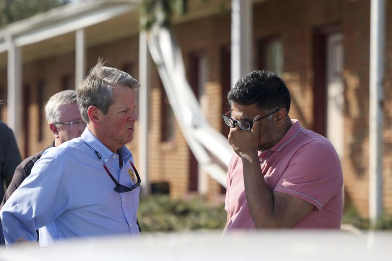 West Point Motel owner Danny Patel, right, reacts as he talks with Governor Brian Kemp at ground zero of the tornado damage, Monday, March 27, 2023, in West Point, Ga.. The West Point Motel was severely damaged from the tornado. Jason Getz / Jason.Getz@ajc.com)
