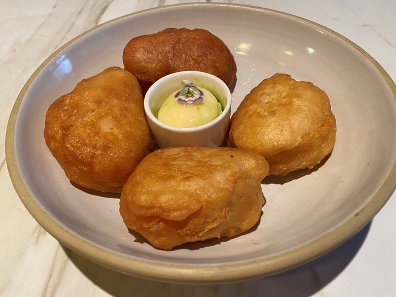 Falling Rabbit offers crumpets as a starter; fried in duck fat and served with honey butter, they are more like fry bread or beignets than the traditional British griddle cake. (Wendell Brock for The Atlanta Journal-Constitution)