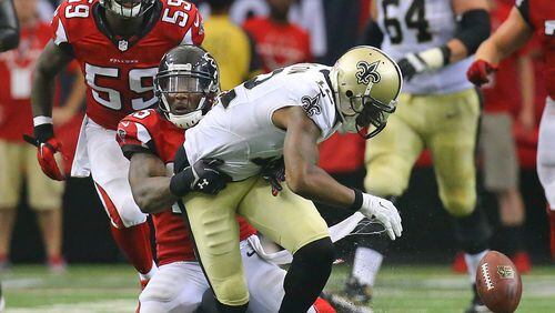 Falcons safety William Moore strips Saints wide receiver Marques Colston causing a fumble recovered by the Falcons in overtime in their NFL football game on Sunday, Sept. 7, 2014, in Atlanta. Falcons linebacker Joplo Bartu (left) recovered the fumble. The Falcons went on to kick a field goal to win the game 37-34. CURTIS COMPTON / CCOMPTON@AJC.COM
