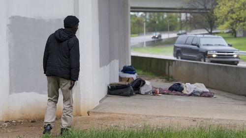 David Hill, 59, points out his belongings under a bridge near I-20 and the Downtown Connector on Monday. (DAVID BARNES / DAVID.BARNES@AJC.COM)