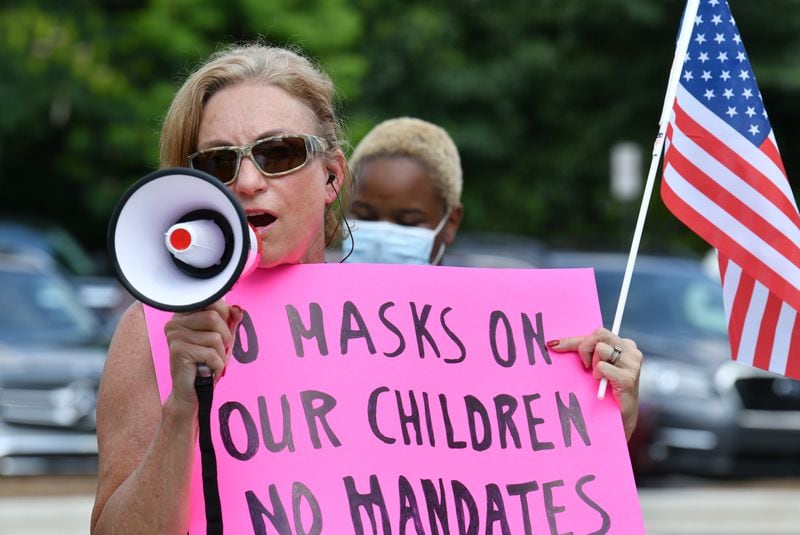 Parents gathered at the headquarters of the Cobb County School District on Aug. 12, 2021, to call for a mask mandate in schools. People who oppose masks in schools also turned out.  (Hyosub Shin / Hyosub.Shin@ajc.com)