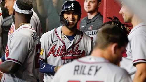 Eddie Rosario smiles in the dugout after his grand slam against the Arizona Diamondbacks during the ninth inning of a baseball game, Sunday, June 4, 2023, in Phoenix. (AP Photo/Darryl Webb)