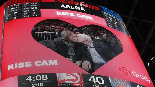 Former President Jimmy Carter kisses his wife, Rosalynn, during the first half of the game between the Hawks and the New York Knicks at State Farm Arena. (AP Photo/John Bazemore)