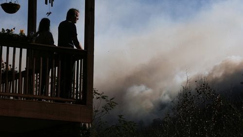 November 16, 2016, Tate City: Eric and Vebbra Willey watch from their porch as the Rock Mountain Fire approaches closer to their home on Wednesday, Nov. 16, 2016, in Tate City. Residents are under a pre-evacuation order as firefighters work to keep the fire away from homes. Curtis Compton/ccompton@ajc.com