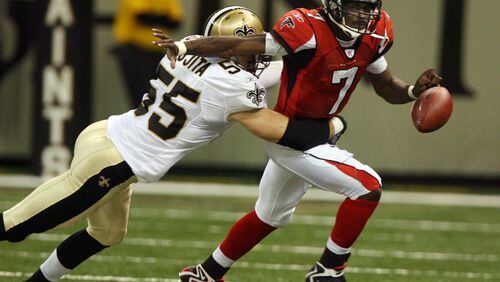 060925 - NEW ORLEANS, LA -- Falcons quarterback Mike Vick (7) fumbles the ball under pressure from Saints Scott Fujita (55) which leads to a New Orleans touchdown on the opening drive in the first quarter of the Falcons at Saints NFL game to reopen the New Orleans Superdome on Monday, Sept. 25, 2006.  (Curtis Compton / AJC staff)
