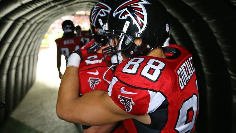 Falcons quarterback Matt Ryan hugs tight end Tony Gonzalez in the Georgia Dome tunnel moments before he takes the field for the final game of his 17-year NFL career on Sunday, Dec. 29, 2013. (Curtis Compton/ccompton@ajc.com)