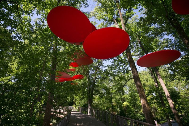 Giant floating red discs, likely to start a conversation among visitors to the Atlanta Botanical Garden, are part of “The Curious Garden,” an art installation by Disney horticulturalist Adam Schwerner. CONTRIBUTED BY ATLANTA BOTANICAL GARDEN
