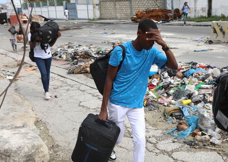 Residents flee their homes in the Delmas 22 neighborhood to escape gang violence in Port-au-Prince, Haiti, Thursday, May 2, 2024. (AP Photo/Odelyn Joseph)