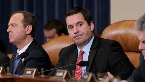 FILE- In this March 20, 2017, file photo, House Intelligence Committee Chairman Rep. Devin Nunes, R-Calif., center, flanked by the committee's ranking member Rep. Adam Schiff, D-Calif., left, and Rep. Peter King, R-N.Y., listens on Capitol Hill in Washington during the committee's hearing on allegations of Russian interference in the 2016 U.S. presidential election. Two weeks after President Donald Trump blocked its full release, the House Intelligence Committee published on Saturday, Feb. 24, 2018, a partially blacked-out version of a classified Democratic memo aiming to counter a GOP narrative that the FBI and Justice Department conspired against Trump as they investigated his ties to Russia. (AP Photo/J. Scott Applewhite, File)