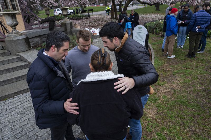 Community members gather in front of the Patterson Park Observatory to participate in a prayer circle in honor of the victims of the collapse of the Francis Scott Key Bridge, in Baltimore, Thursday, March 28, 2024. The prayer circle was hosted by Redemption City Church. (Kaitlin Newman/The Baltimore Banner via AP)