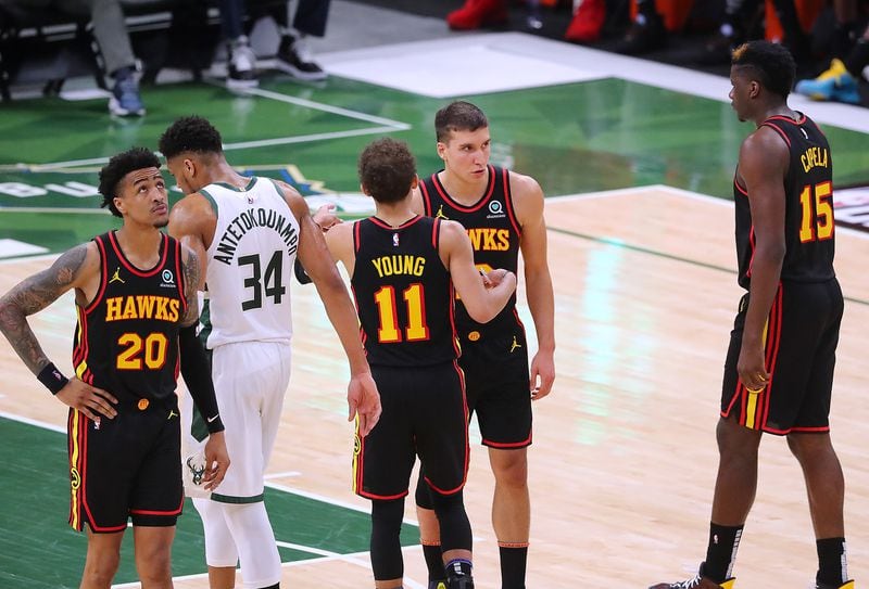 Hawks players John Collins, Trae Young, Bogdan Bogdanovic, and Clint Capela look for answers.   “Curtis Compton / Curtis.Compton@ajc.com”