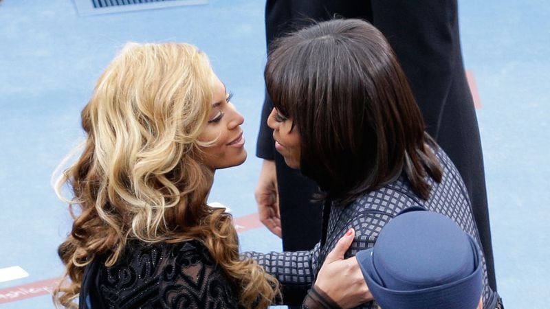 First lady Michelle Obama greets singer Beyonce after she performs the National Anthem during the public ceremonial inauguration on the West Front of the U.S. Capitol January 21, 2013 in Washington, DC.