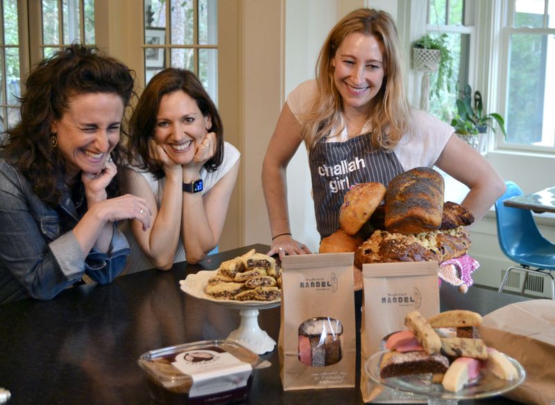 Amy Birnbaum, Joanna Kobylivker, and Jaci Effron share a laugh over a bounty of their baked goods. CONTRIBUTED BY BRAD KAPLAN