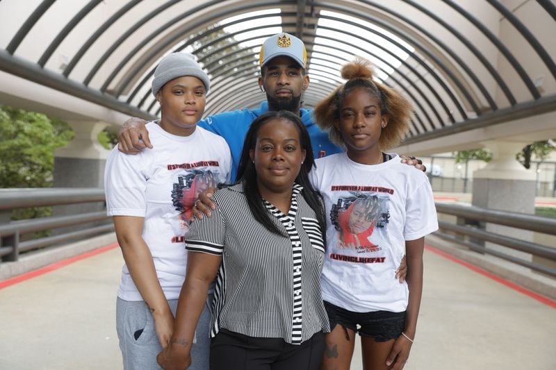 Ashley Heard (center) the mother of 15-year-old Charles Brown stands with her daughter-in-law Nicole Gantt( left), her husband Franklin Gillis (back), and daughter Takayla Blake (right) on Friday.(Natrice Miller/ natrice.miller@ajc.com)
