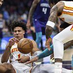 Jalen Johnson of the Hawks fights for a loose ball during Wednesday's game against the Hornets. Atlanta lost the road game 122-99 in its final game before the All-Star break.