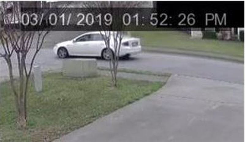 Investigators have released surveillance footage of a white Acura spotted leaving the scene of a fatal Lawrenceville shooting Friday afternoon.