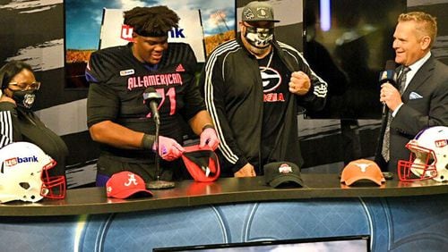 Offensive lineman Earnest Greene of Los Angeles prepares to put on his Georgia Bulldogs cap moments after announcing on national television that he signed with the Bulldogs. He announced Jan. 8, 2022 after signing his letter of intent Dec. 15. (Photo courtesy of 247Sports)
