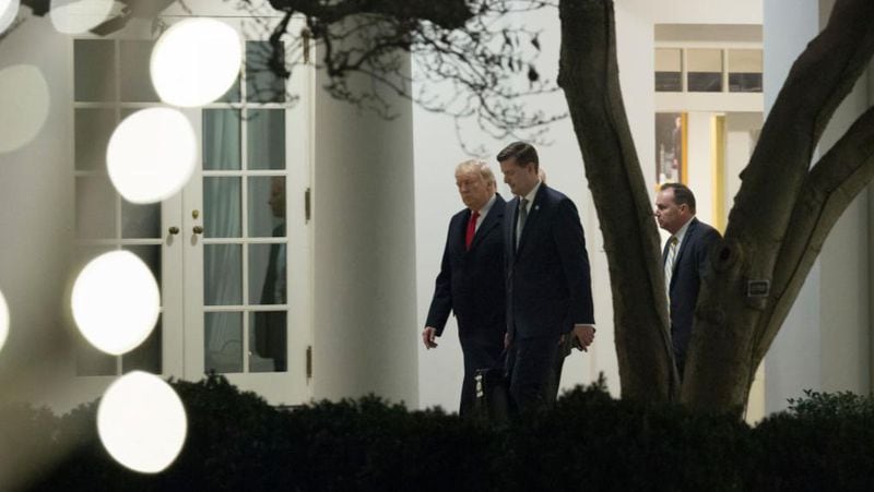 President Donald Trump speaks with White House Staff Secretary Rob Porter (C) and Sen. Mike Lee (R-UT) (R) as they return to the White House December 4, 2017 in Washington, DC. President Trump traveled to Utah to announce his plan to shrink the Bears Ears and Grand Staircase-Escalante national monuments.  