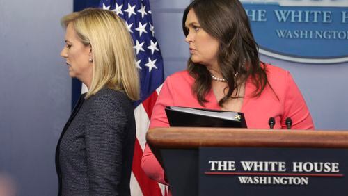 Homeland Security Secretary Kirstjen Nielsen, left, leaves the White House briefing room as press secretary Sarah Huckabee Sanders walks to the podium in this June 18 file photo. Oliver Contreras/Sipa USA/TNS