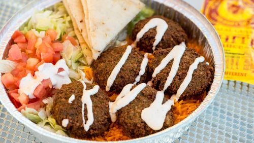 Falafel platter with rice, lettuce, tomato, grilled pita, and special white sauce from The Halal Guys. Photo credit- Mia Yakel.