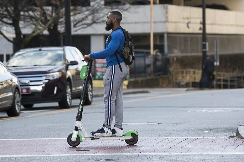  A man rides a Lime Scooter on Peachtree Street in Atlanta’s Midtown community, Friday, January 4, 2019. (ALYSSA POINTER/ALYSSA.POINTER@AJC.COM)