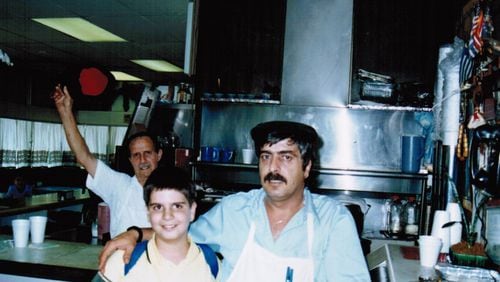 Grecian Gyro opened its first location in Hapeville nearly 40 years ago. Here George Koulouris (left) with his father Nick Koulouris. George and his brother Pano Koulouris currently run the family business and its seven restaurants. Two locations of the restaurant opened on Thanksgiving Day, providing free meals to about 200 people in the giving-back spirit that their father instilled in them. Courtesy of George Koulouris