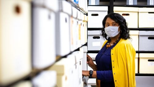 Feechi Hall, University Archivist of Clayton State University, poses for a portrait in the University Archives at the Clayton State University campus in Morrow. Hall is currently working to collect submissions that document COVID-19 and its effect on both the university and the surrounding community. (Casey Sykes for The Atlanta Journal-Constitution)