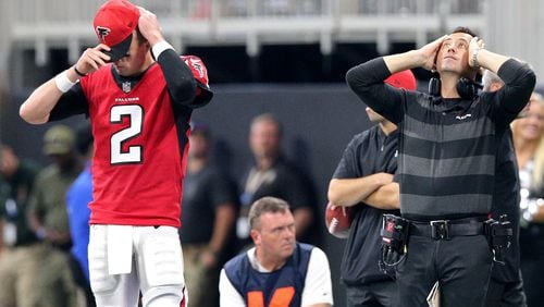 Atlanta Falcons quarterback Matt Ryan and offensive coordinator Steve Sarkisian react on the sidelines as the New Orleans Saints win the game 43-37 on a Dree Brees touchdown in overtime during an NFL football game on Sunday, Sept 23, 2018, in Atlanta.   Curtis Compton/ccompton@ajc.com