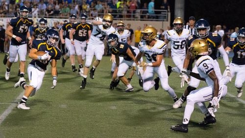 Marist's Jackson Brennan looks for yardage against St. Pius Friday. (Drew Dinwiddie/Special)