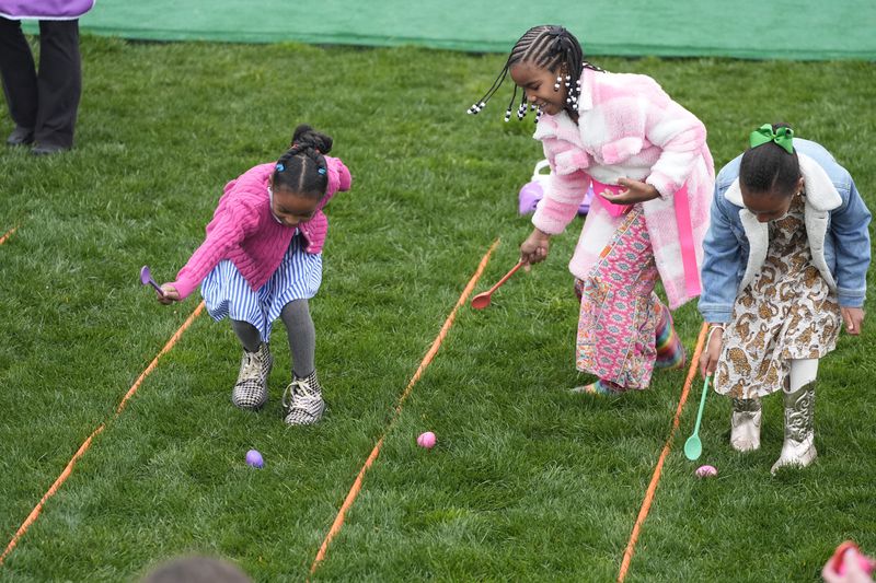 The White House Easter Egg Roll begins on the South Lawn of the White House in Washington, Monday, April 1, 2024. Thunder and lightning delayed the start of the Easter egg roll at the White House for 90 minutes on Monday, but the event eventually kicked off under gray skies and internment rain. More than 40,000 people, 10,000 more than last year, were expected to participate in the event. (AP Photo/Mark Schiefelbein)