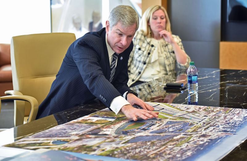 January 10, 2017 Atlanta - Georgia State President Mark Becker shows off new renderings at Carter & Associates LLC on Tuesday, January 10, 2017. On Tuesday, Georgia State University and the private development team that acquired the former Atlanta Braves stadium near downtown showed off new renderings showing the design concepts of what they hope to build on the 68-acre site. HYOSUB SHIN / HSHIN@AJC.COM