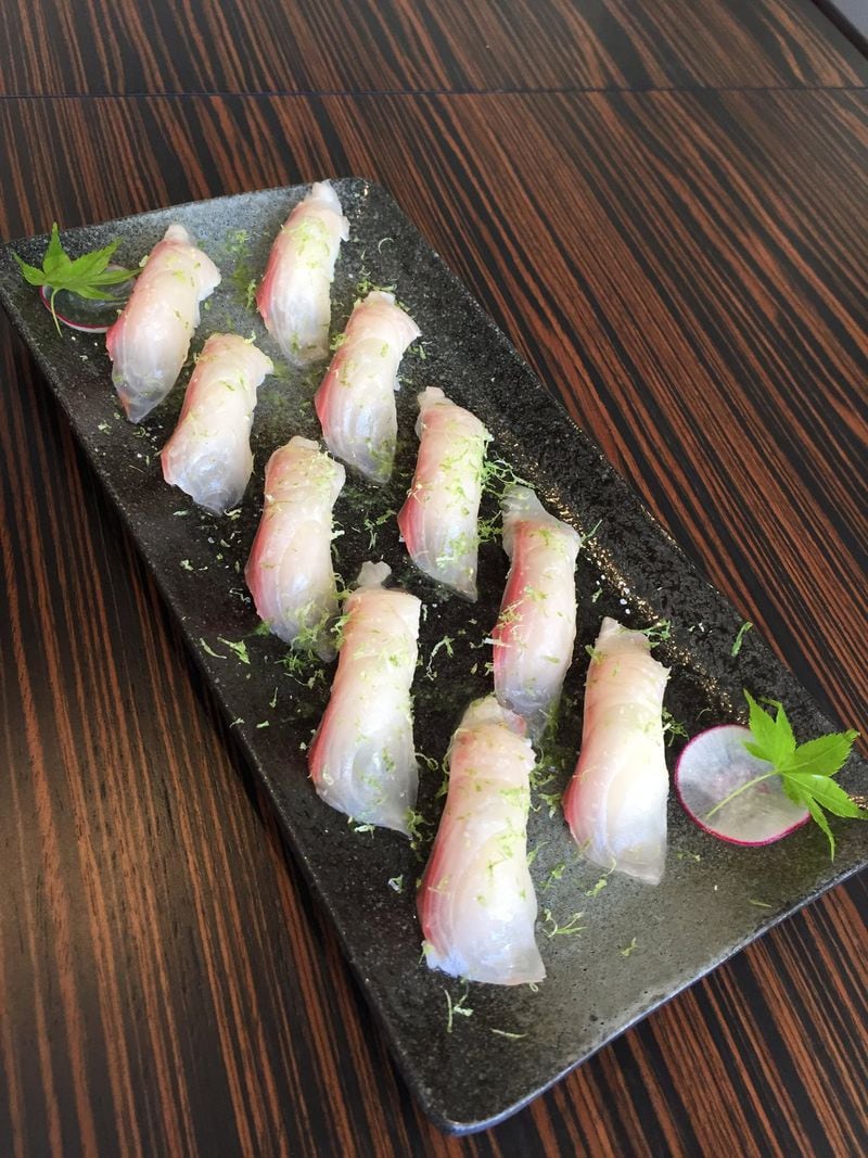 MF Bar offers hot and cold plates, as well as sushi rolls and nigiri — like this kampachi with lime zest. CONTRIBUTED BY JESSIE DOWD